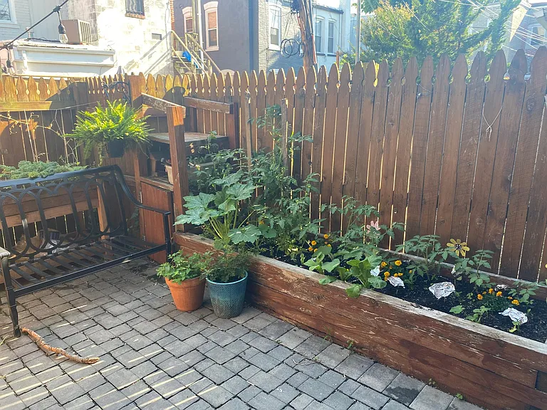 Rear patio, gas grill not visible but is to the right of garden. Grill fuel is natural gas line extended from house, no need for propane or charcoal.