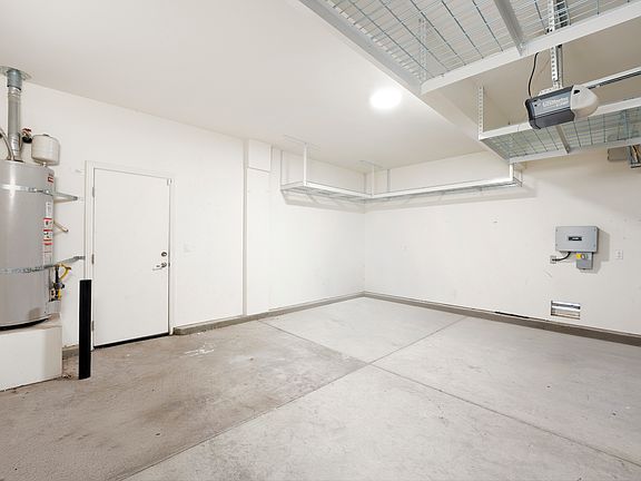 2 car garage with plenty of overhead storage racks.