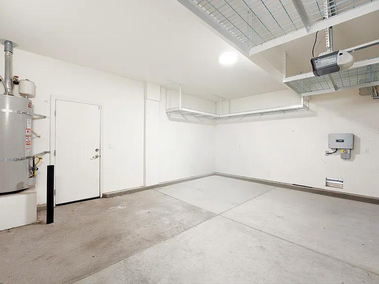 2 car garage with plenty of overhead storage racks.