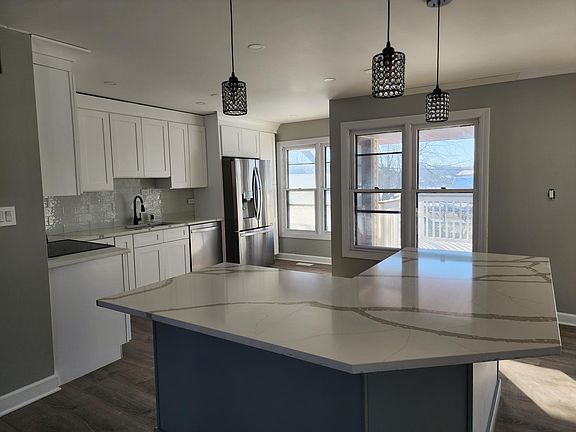 Second Floor: Brand new kitchen, with stainless steel appliances, extra large fridge, and large kitchen Island.