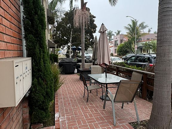 View of the mailboxes and community front patio with BBQ.