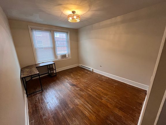 Bedroom with provided L-shaped desk