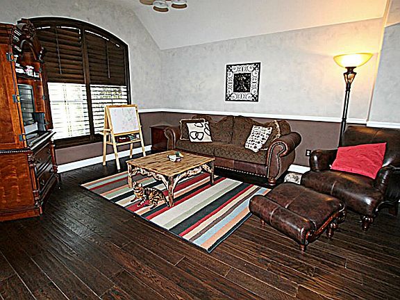 ENJOY INTIMATE GATHERINGS WITH YOUR FRIENDS AND FAMILY IN THE FORMAL LIVING ROOM WITH CHAIR RAILING.