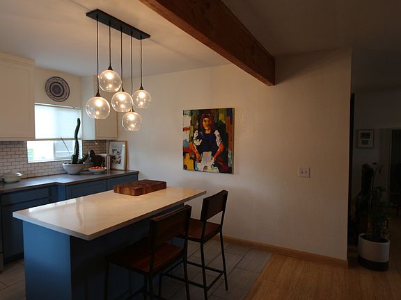 Kitchen also has quartz counter top and subway tile backspla