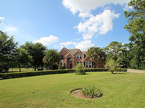 Mature landscaping and well-maintained grounds enhance the curb appeal.