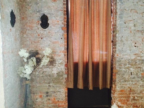 exposed brick with window to the courtyard