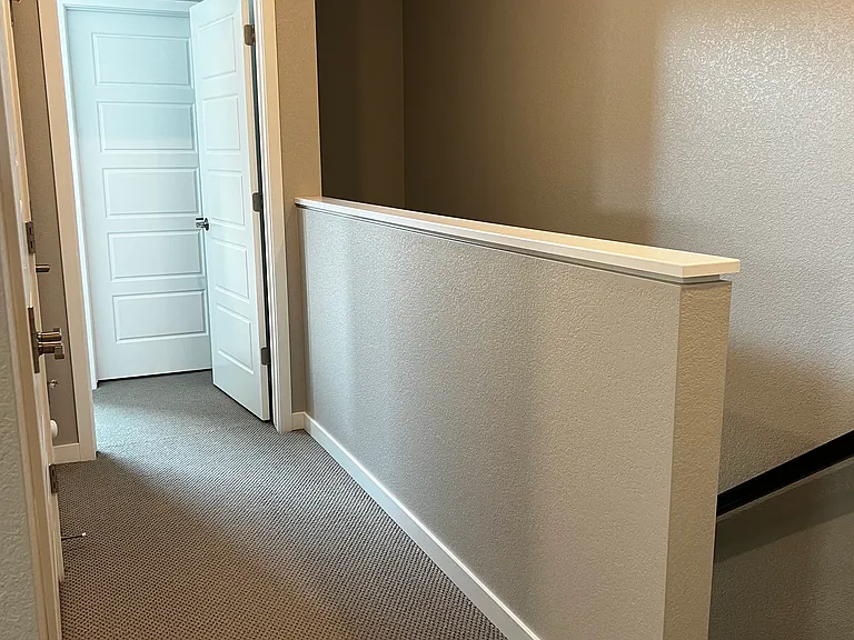 Stairs leading to 2nd floor and hallway leading to closet