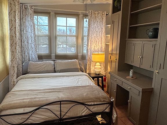 Bedroom with builtins and smart TV (not shown)