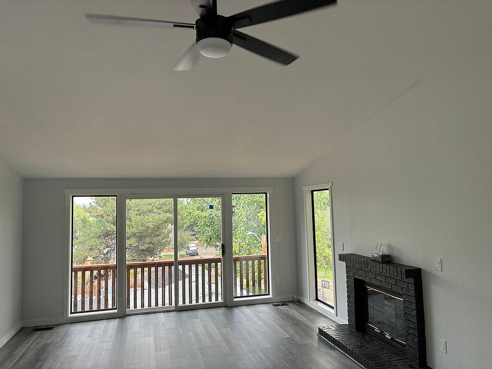 Open floor plan living space with a gas fireplace. Many windows to allow natural light into the space.