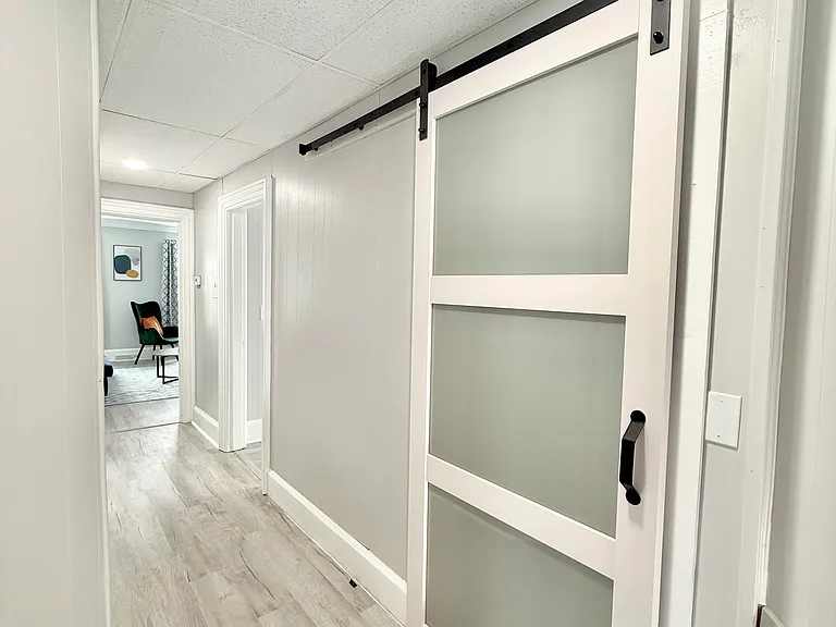The beautiful modern sliding barn door adds a touch of style while saving space and making the bathroom feel roomier and more open.