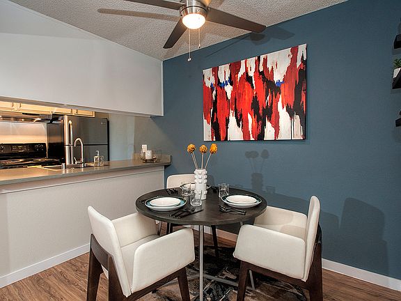 View Of Dining Room With Blue Accent Wall With Decor