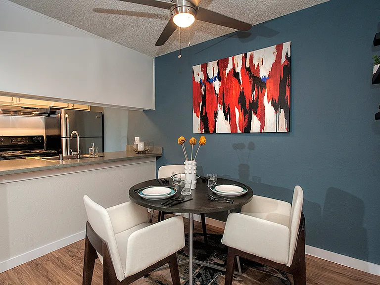 View Of Dining Room With Blue Accent Wall With Decor