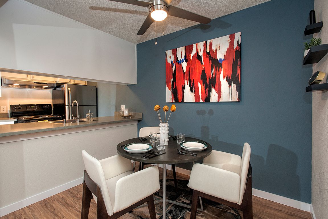 View Of Dining Room With Blue Accent Wall With Decor