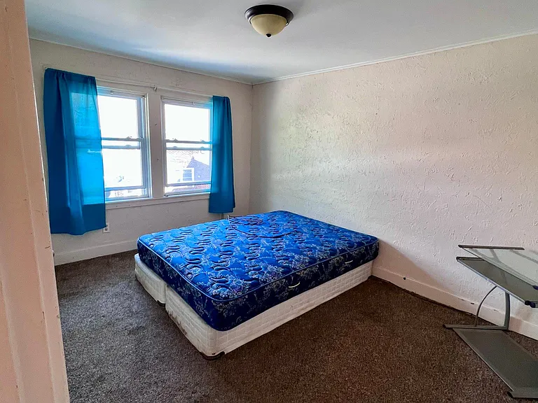 back bedroom (faces back porch and side driveway/alley)