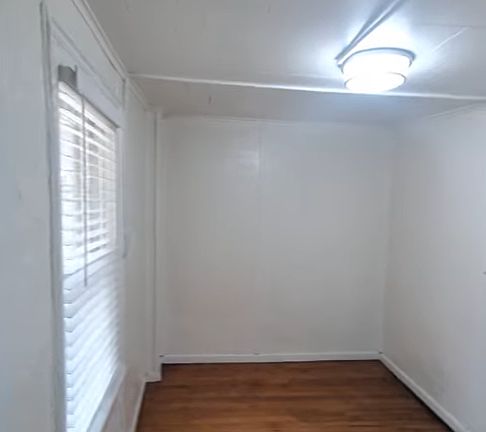 Bedroom/bonus room with closet off of hallway next to kitchen.