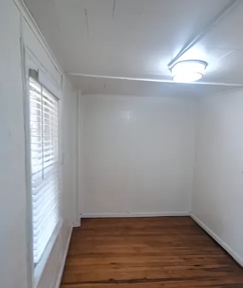 Bedroom/bonus room with closet off of hallway next to kitchen.