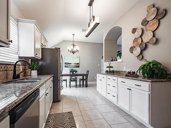 Well appointed galley kitchen with stainless steel appliances and plenty of storage and counter space for preparing your favorite meals.