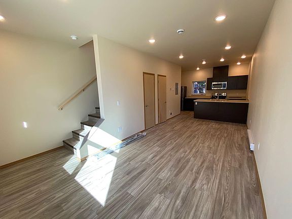 Looking at living room, 1/2 bath is the second door on the left, kitchen in back