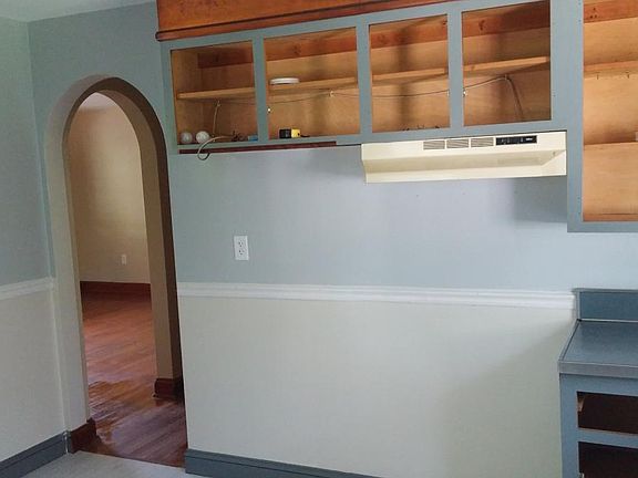 Kitchen with cabinet doors removed for painting