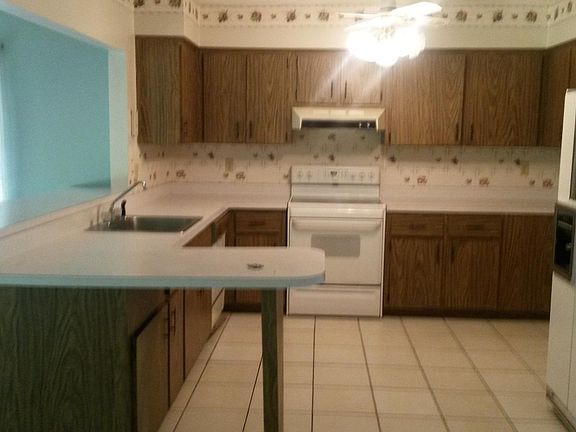 Large open kitchen with breakfast bar and additional living 