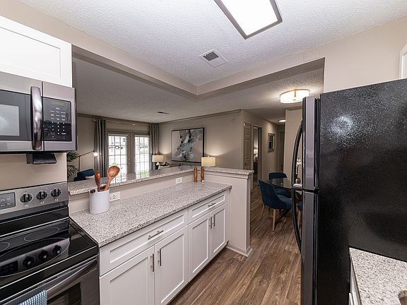 Kitchen with granite counters, modern cabinetry, and stainless appliances