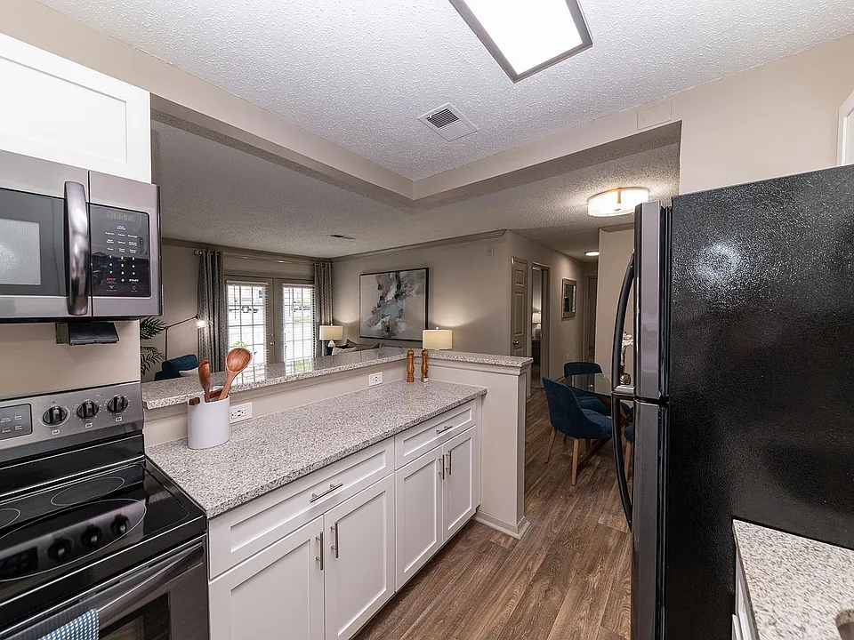 Kitchen with granite counters, modern cabinetry, and stainless appliances