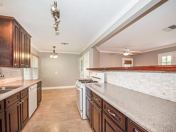 Granite countertops and tile backsplash. Lots of cabinets and drawers. Brushed nickel hardware.