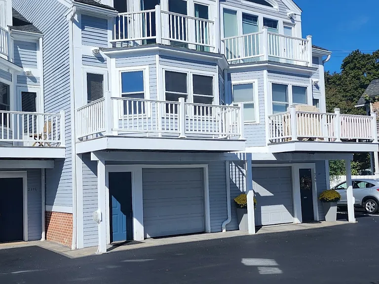 Beautiful waterfront condo with private balconies, garage parking, and modern coastal design.