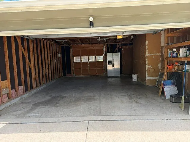 Large 2 car garage with storage shelves