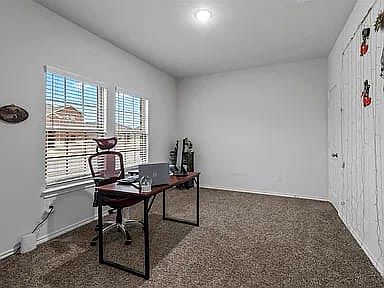 Office with attached closet/storage.