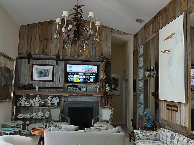 Living rm custom chandelier, Natural Drift wood fire place mantel and antique barn wood wall features.
Mid-century furnishings
