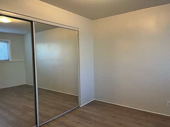 Your bedroom with brand new flooring and mirrored closet doors