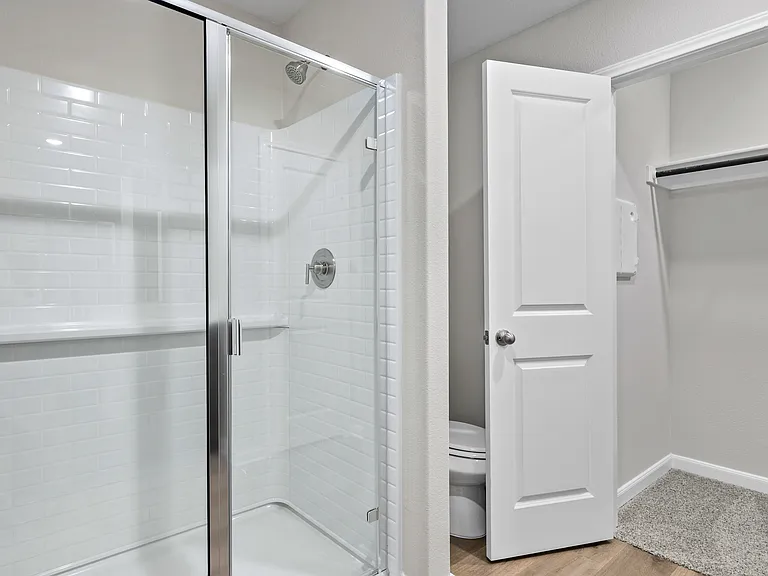 The master bathroom has a glass walk-in shower.