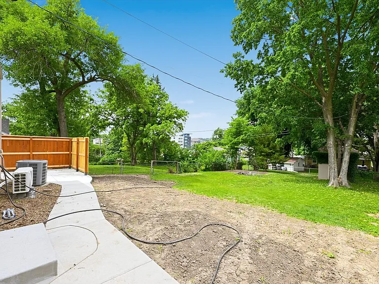 Large, fully-fenced yard with gate and storage shed.