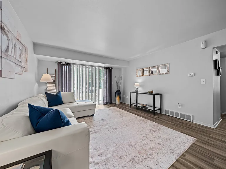 Spacious living room with natural light at Westwood Village Apartments in Westland, MI