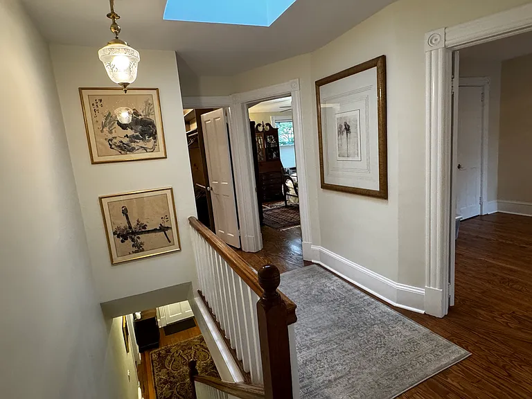 Upstairs hall looking toward front of house (right door to 3rd bedroom; middle door to 2nd bedroom; left door to large walk-in closet).