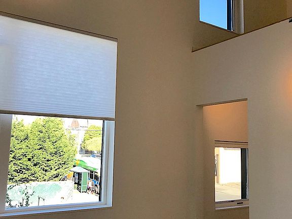 East facing bedroom has a walk-in closet and high storage loft