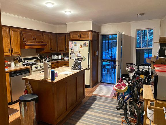 Kitchen from dining room doorway. There is a small eat-in area by the window.