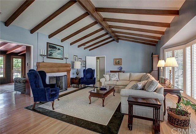 Vaulted ceilings, large bay window, stunning and unique fireplace adds to the ambiance of the living room.