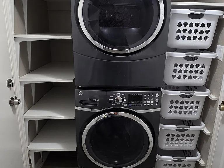 Double stacked large washer and dryer with built-in sorting bins to the right