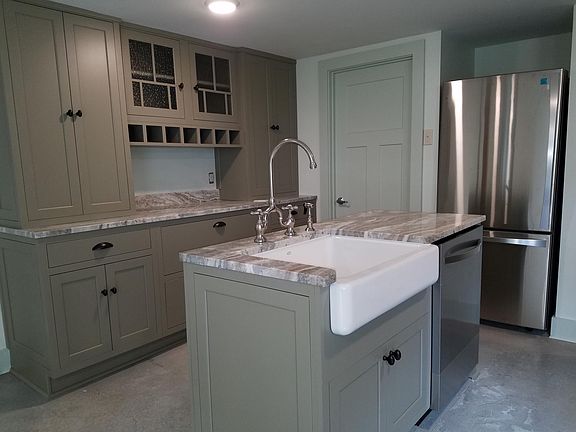 Custom cabinets, farm sink stainless dishwasher and refrigerator
