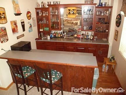 bar in walkout basement
						:
						lots of shelves, glass doors, mini fridge and bar sink, AB mirror