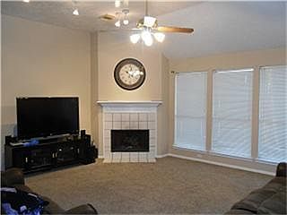 Large den with corner fireplace.