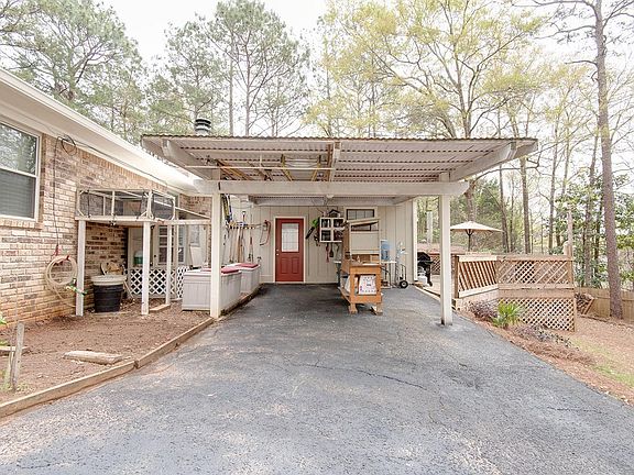 Back of home: carport, deck, yard