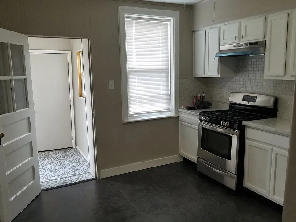 Gas stove and sunroom off kitchen.