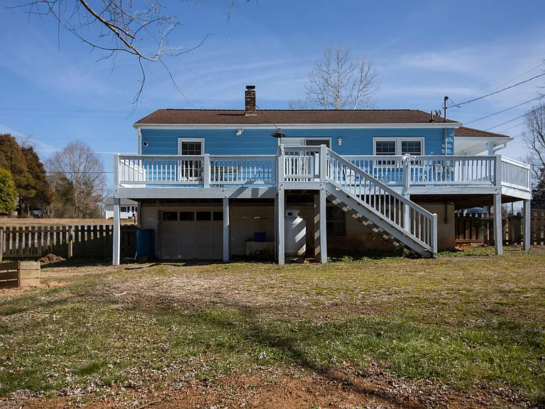 View from the fenced-in backyard. There is tons of storage beneath the house.