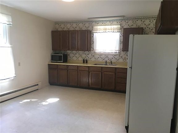 KITCHEN has a pantry to the right, electric range and refrigerator.  There is room for a large table without feeling crowded.