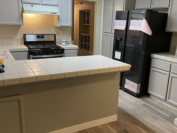 Newly painted cabinets, new refrigerator