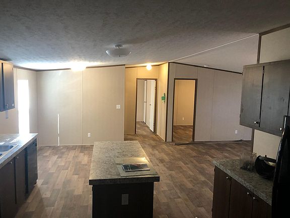 View from the laundry room door showing access to spare rooms.