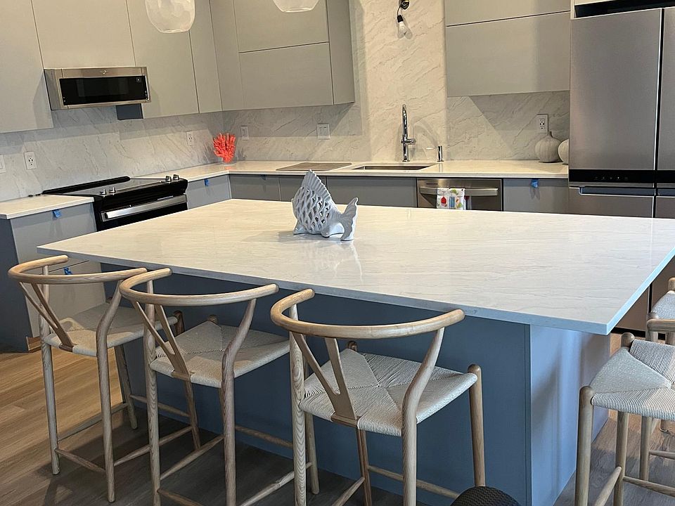 Newly renovated top of the line kitchen with stainless appliances and quartz island, counter tops and full backsplash